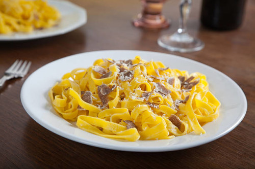 typical Italian pasta with truffle slices and parmesan cheese